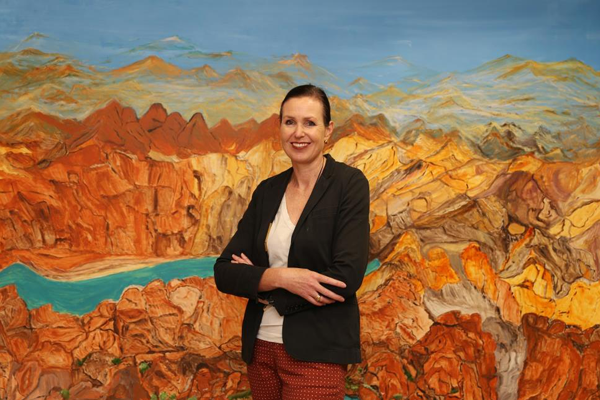 Dr Rebecca Coates in front of Angelina Gorge's painting in SAM's collection